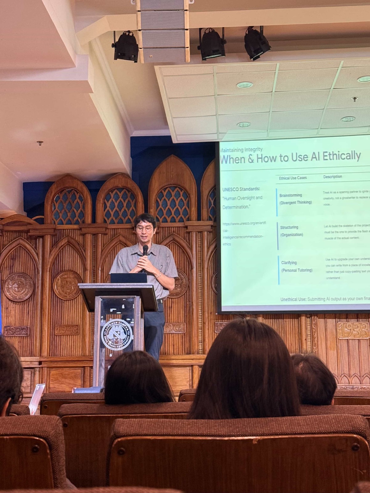 Me at the podium mid-talk, the slide behind me reading When and How to Use AI Ethically, with the UNESCO line about human oversight and determination