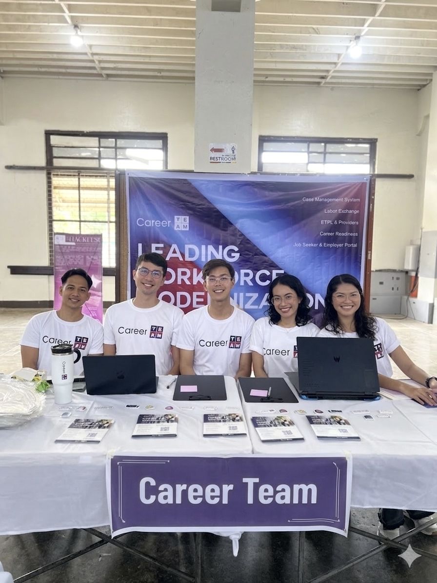 The five of us behind the Career Team booth in matching white shirts, laptops open, flyers and a QR code laid out across the table